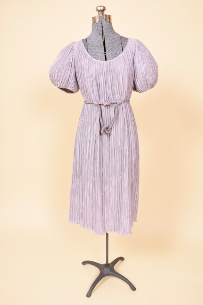 Vintage lilac Pierre Labiche eighties micropleat midi dress is shown from the front. This dress is shown styled with a rope belt to cinch the waist.  
