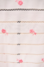 Load image into Gallery viewer, Vintage white and pink rose embroidered slip skirt is shown in close up. This sheer lingerie skirt has lacy horizontal stripes. 
