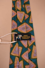 Load image into Gallery viewer, Vintage green silk triangle print tie shown from the back making the tag visible. The tie&#39;s tag reads Hart Schaffner &amp; Marx.
