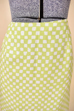 Load image into Gallery viewer, Vintage 2000&#39;s lime green and white grid print Versace mini skirt is shown in close up. This skirt has a pencil skirt silhouette. 
