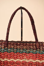 Load image into Gallery viewer, Vintage 70s colorful stripe woven purse is shown in close up. This colorful stripe purse has a top handle. 
