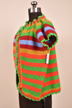 Load image into Gallery viewer, Vintage 70s handmade colorful striped knit short sleeve cardigan is shown from the side. This cardigan has puff sleeves.
