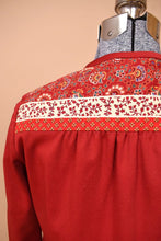 Load image into Gallery viewer, Vintage seventies red maxi dress bolero jacket is shown in close up. This jacket has a floral multicolor paisley print jacket.

