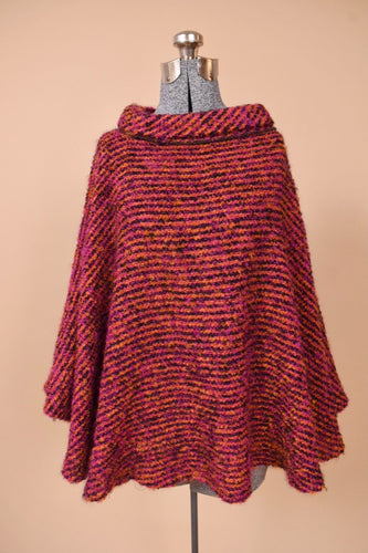 Vintage pink woven boucle cape is shown from the front. This Irish wool cape has a turtleneck.