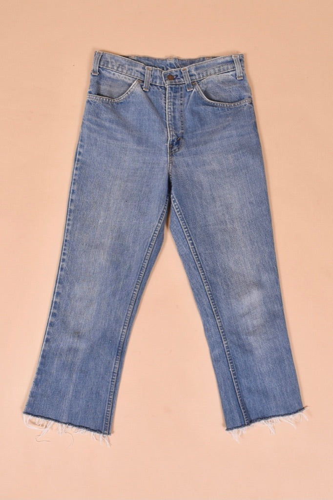 Vintage 1970's Levis orange tab raw hem jeans are shown from the front. 