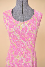 Load image into Gallery viewer, Vintage eighties pink printed maxi dress is shown in close up. This dress has a pink and green geometric paisley print. 
