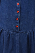Load image into Gallery viewer, Vintage dark denim maxi length full skirt dress is shown in close up. This dress has red plastic buttons down the front. 

