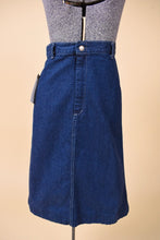 Load image into Gallery viewer, Vintage 70&#39;s high rise dark denim midi length skirt is shown from the front. This skirt has a slightly flare shape. 
