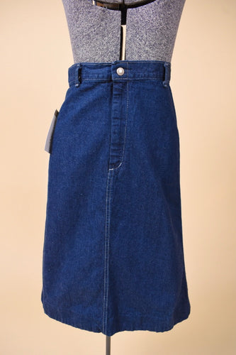 Vintage 70's high rise dark denim midi length skirt is shown from the front. This skirt has a slightly flare shape. 