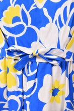 Load image into Gallery viewer, Vintage blue and yellow 60s floral mod dress is shown in close up. This dress has an empire waist with a bow. 
