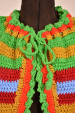 Load image into Gallery viewer, Vintage seventies green, orange, and blue striped knit puff sleeve cardigan is shown in close up. 
