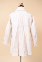 Load image into Gallery viewer, Vintage sixties leather swing coat by Sills Bonnie Cashin is shown from the back. This swing coat is a bright white leather.
