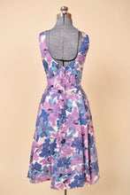 Load image into Gallery viewer, Vintage fifties blue and purple springy tea dress is shown from the back. This dress has a low scoop back neckline. 
