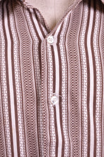 Load image into Gallery viewer, 1970s men&#39;s vintage brown and white striped top is shown in close up. This men&#39;s shirt has a geometric print stripe pattern. 

