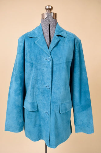 Vintage turquoise suede blazer by Jessica Holbrook is shown from the front. This suede jacket has three blue buttons down the front. 