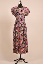 Load image into Gallery viewer, Vintage pink floral rayon crepe dress by Carole Little is shown from the front. This dress has cap sleeves. 
