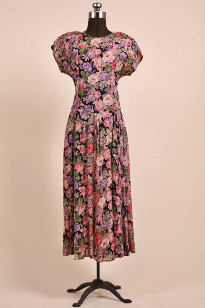 Vintage pink floral rayon crepe dress by Carole Little is shown from the front. This dress has cap sleeves. 