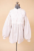 Load image into Gallery viewer, Vintage 1970s bohemian white puff sleeve blouse is shown from the front. This poet blouse has puffy sleeves. 

