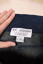 Load image into Gallery viewer, Vintage navy denim stretch bell bottom mid rise designer jeans are shown in close up. These jeans have a tag that reads St John Couture by Marie Gray. 
