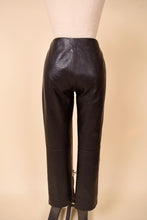 Load image into Gallery viewer, Vintage low rise dark brown leather trouser pants are shown from the back. These pants are by the brand Identify.
