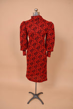 Load image into Gallery viewer, Vintage 80&#39;s red and black geometric patterned knit dress is shown from the front. This dress has a turtleneck collar.
