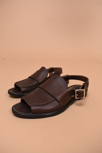 Brown leather designer sandals by Marni are shown from the side. These sandals have a peep toe.