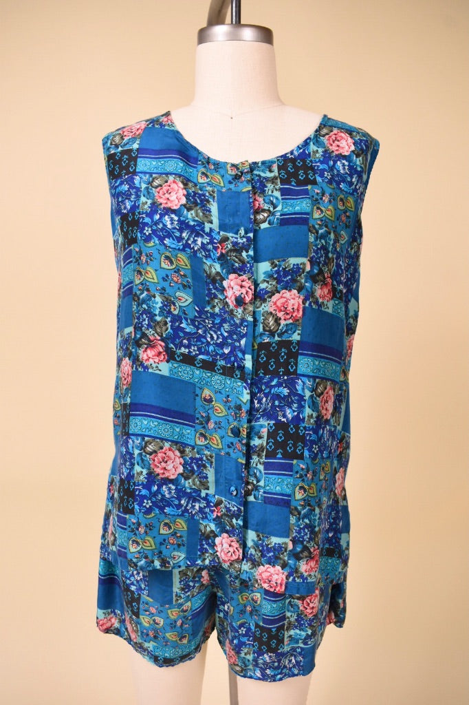 Vintage Y2K two piece blue and pink floral patchwork print two piece set is shown from the front. This In Stock two piece set it a button down tank and shorts.