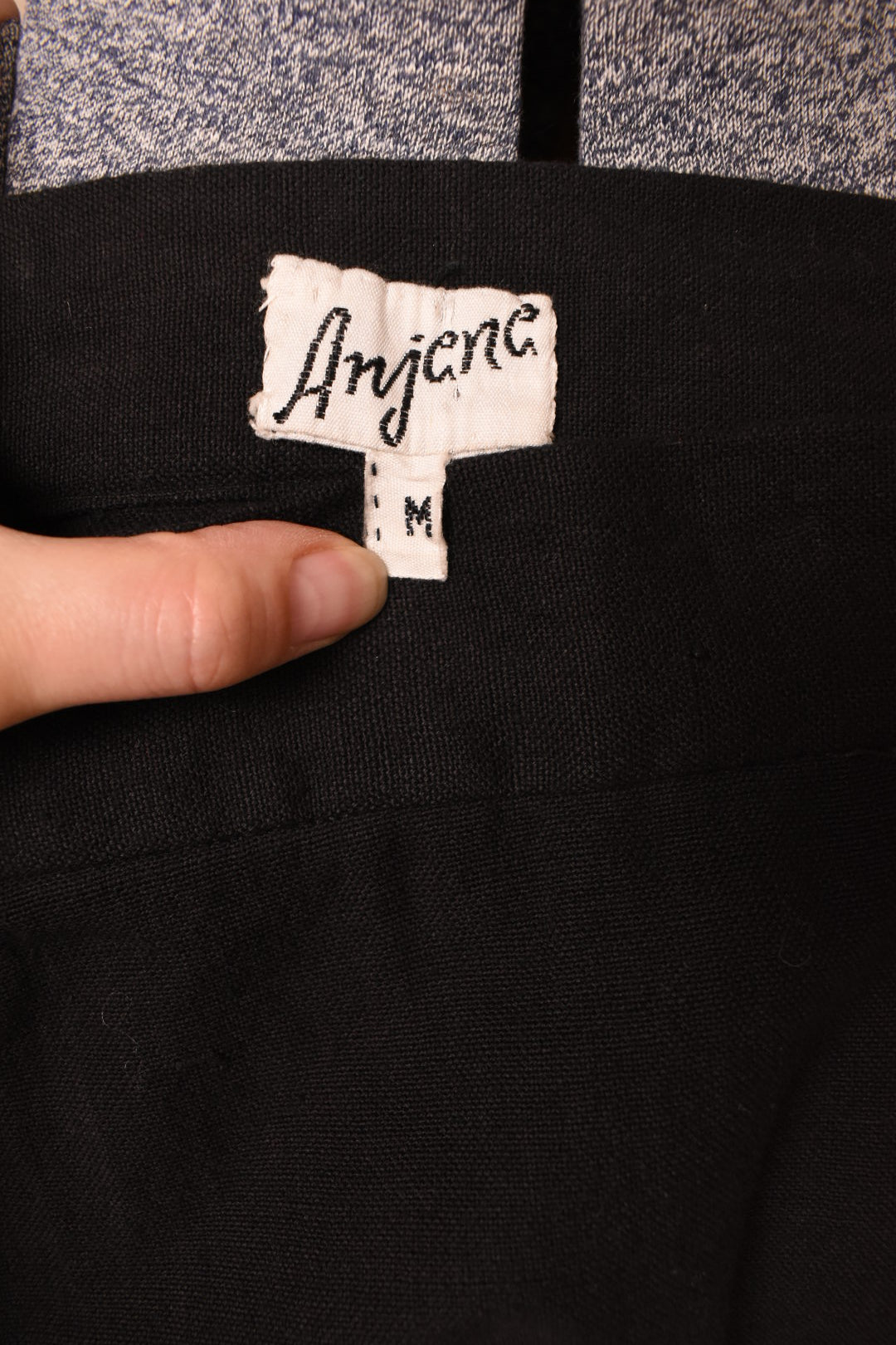Vintage black 1960's embroidered cotton maxi skirt is shown in close up. This skirt has a tag that reads Anjana. 