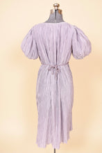 Load image into Gallery viewer, Vintage Pierre Labiche eighties pastel purple micropleat grecian dress is shown from the back. This purple midi length dress has puff sleeves. 
