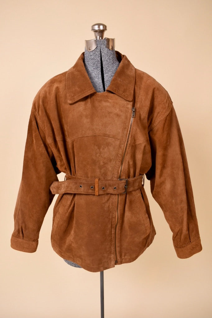 Vintage 1980's brown suede jacket by Together! is shown from the front. This asymmetrical suede jacket has a zipper up the side. 