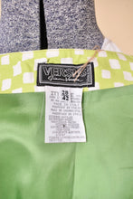 Load image into Gallery viewer, Vintage Y2K green and white check print skirt is shown in close up. This skirt has a tag that reads Versus Gianni Versace. 
