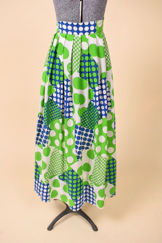 Vintage 1960's green and blue patchwork pattern polka dot maxi skirt is shown from the front. This skirt has a high waisted fit. 