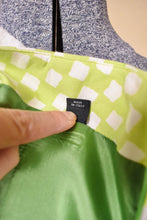 Load image into Gallery viewer, Vintage lime green and white check print skirt is shown in close up. This Versace skirt is Made in Italy. 
