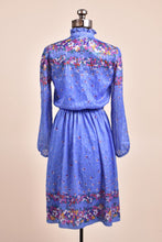 Load image into Gallery viewer, Vintage seventies blue floral print boho midi dress is shown from the back. This dress has red and yellow floral designs. 
