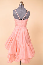 Load image into Gallery viewer, Vintage fifties peach pink ruffle skirt party dress by Nikos Nataba is shown from the back. 
