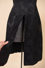 Load image into Gallery viewer, Vintage 1960&#39;s black silk jacquard tunic dress is shown in close up. This swirl print dress has a super high slit up the skirt. 
