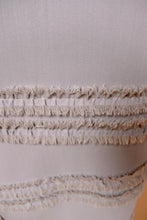 Load image into Gallery viewer, Part of the skirt fringe is visible in detail.
