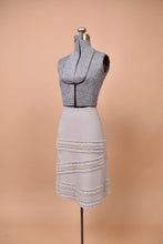 Load image into Gallery viewer, The skirt is angled to the left on a mannequin.
