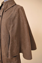 Load image into Gallery viewer, Vintage 60s olive green waxed canvas raincoat by Le Clan J is shown in close up. This jacket has cape sleeves. 
