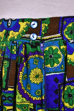 Load image into Gallery viewer, Vintage seventies XL stained glass print maxi skirt is shown in close up. This skirt has two blue buttons at the waist.
