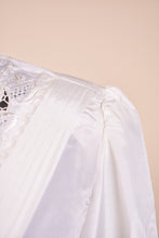 Load image into Gallery viewer, Vintage white lace puff sleeve blouse is shown in close up. This blouse has shoulder pads.
