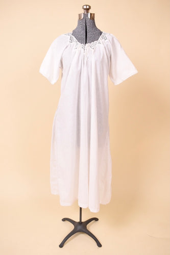 Antique white crochet neckline nightgown is shown from the front. This maxi length nightgown has a ribbon at the neckline.