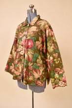 Load image into Gallery viewer, Vintage olive green floral print chore coat is shown from the side. This jacket has a pink flower print. 
