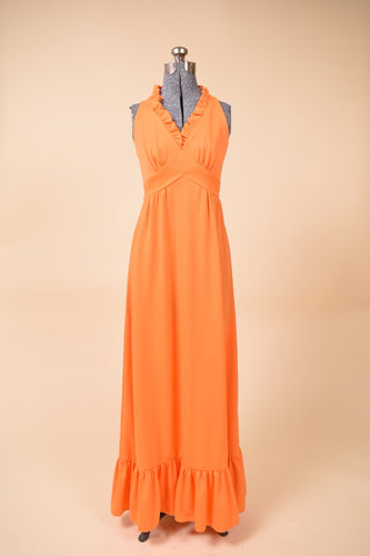 Vintage orange polyester 1970's ruffled maxi length gown is shown from the front. This dress has an empire waist.