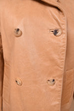 Load image into Gallery viewer, Vintage beige leather jacket is shown in close up. This jacket has four tortoiseshell buttons on the front. 
