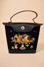 Load image into Gallery viewer, Vintage Enid Collins black fruit platter bucket bag is shown from the front. This bag has a gold tone turnlock on the front. 

