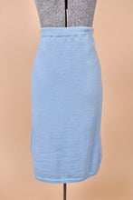 Load image into Gallery viewer, Vintage 70s pastel blue midi length pencil skirt is shown in close up. This skirt has a stretchy waistband.
