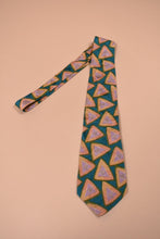 Load image into Gallery viewer, Silk triangle print tie shown from above. The tie is green with yellow and pink triangles.
