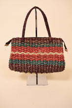 Load image into Gallery viewer, Vintage colorful striped woven seagrass handbag is shown from the front. This woven bag has maroon, blue, and red dyed seagrass. 
