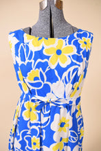 Load image into Gallery viewer, Vintage 1960&#39;s blue and yellow flower print boat neckline midi dress is shown in close up. 
